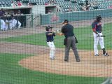 Bat Boy Giving Ball to Umpire