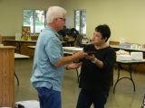 Sherry Presents Merrill with an Award from International