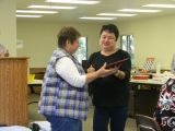 Sherry Presents Pam with an Award from International